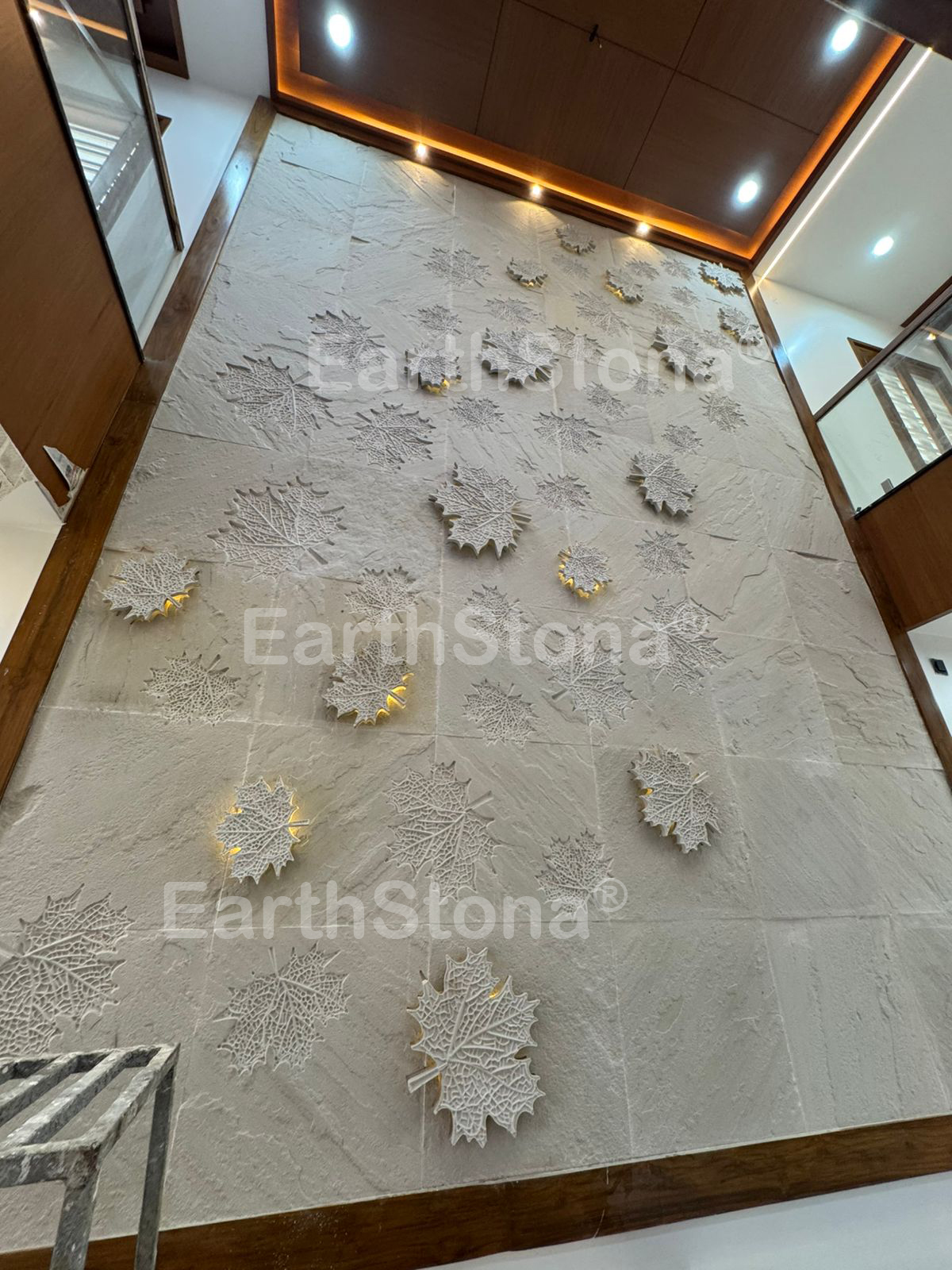 Mapple leaf with light on natural stone wall carving art